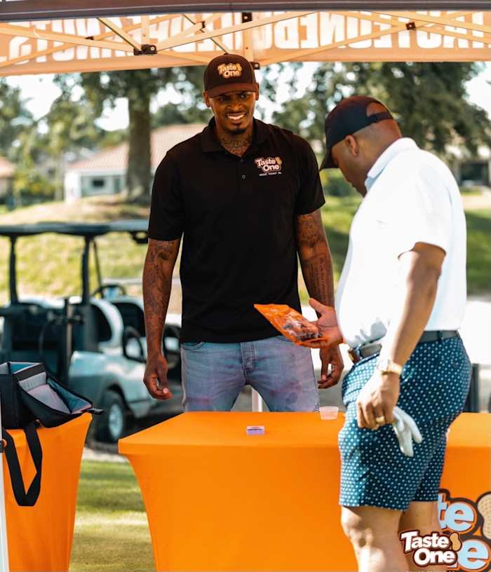 He's only one man, but Leggett is constantly on the move, showing up at events, tailgates, promotions and charities. He's not hard to find as he's always posted up with his bright orange Taste One tent, with a microwave and boxes of peanuts on deck.